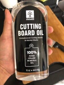 Mevell Cutting Board Oil in hand